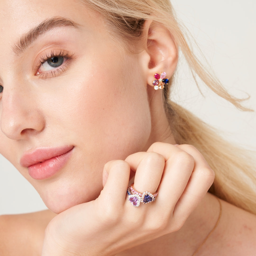 A beautiful model wearing Diana rings and Florea flower earrings set with lab grown diamond, purple sapphire, pink sapphire, blue sapphire and champagne sapphire