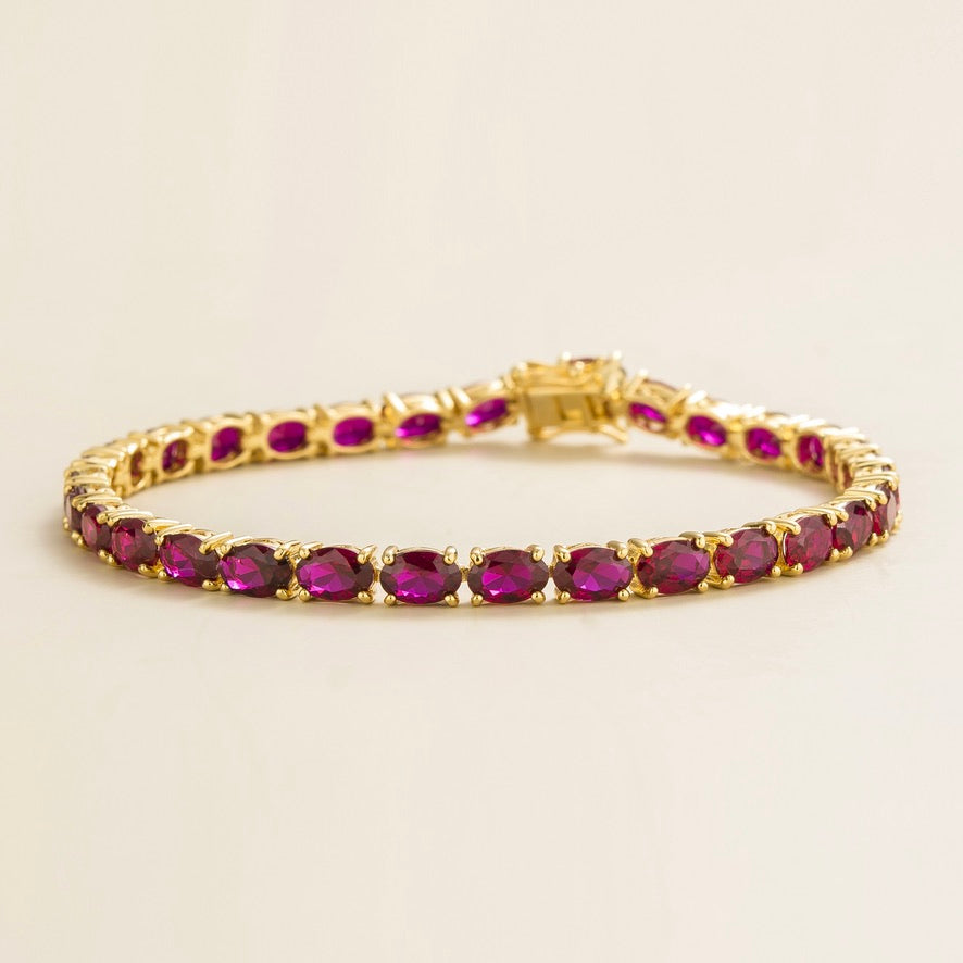 Oval lab-grown ruby tennis bracelet in gold | Juvetti London