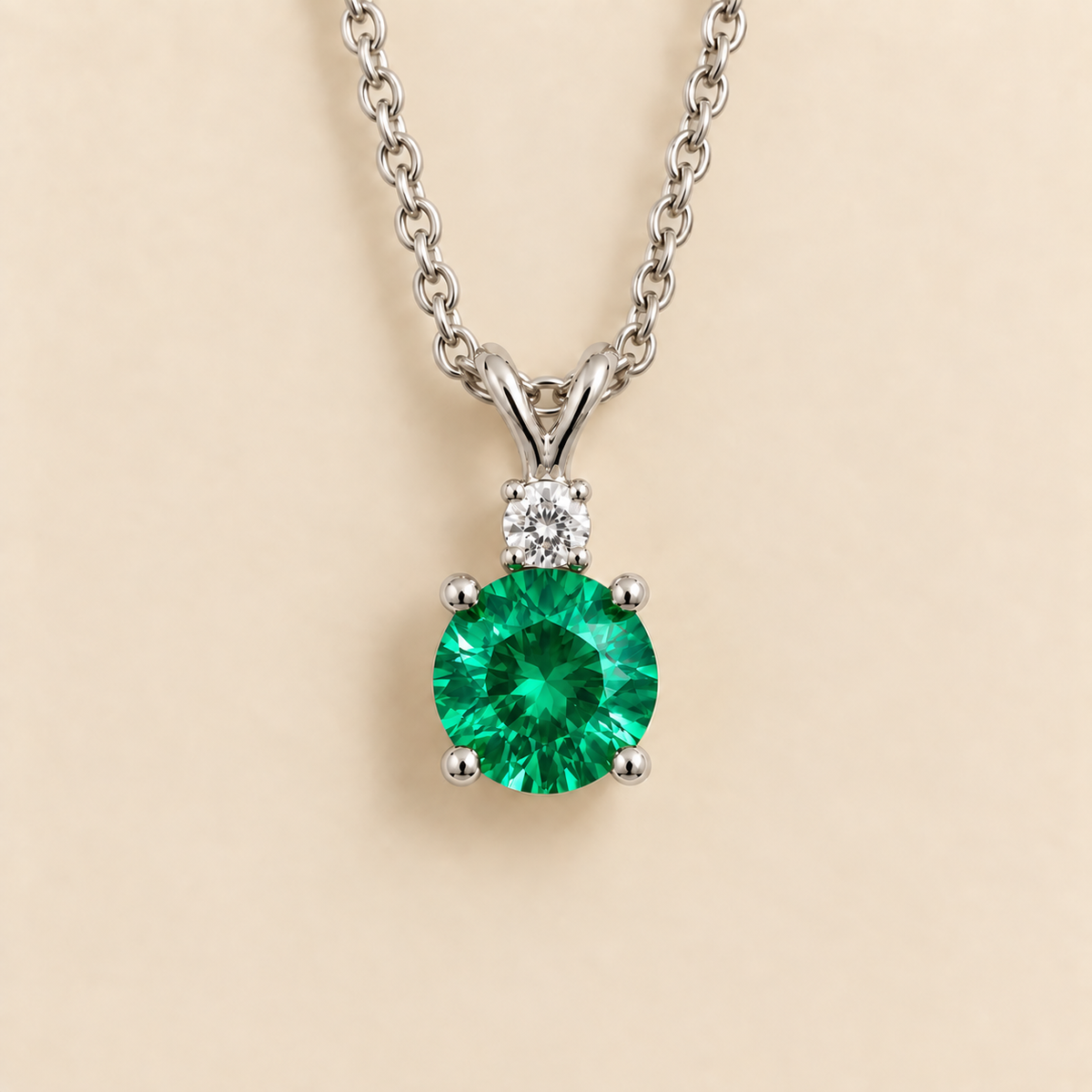 Round lab-grown emerald and diamond drop pendant necklace, Joie design in white gold | Juvetti London