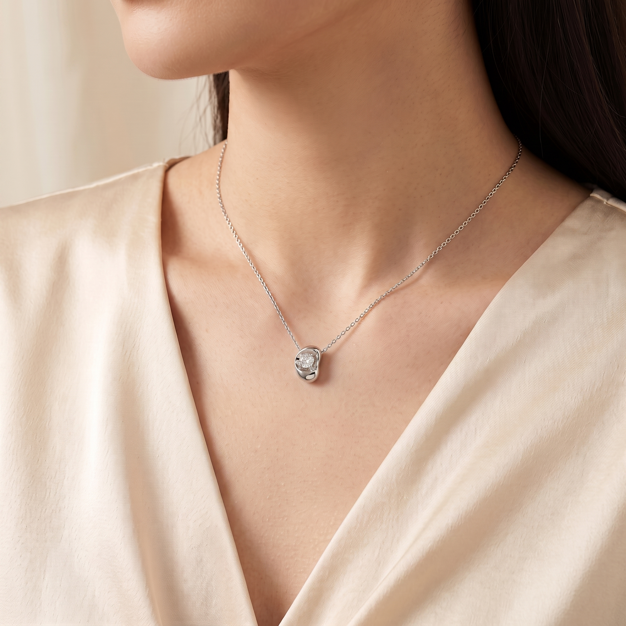 A model is wearing Fava Round Diamond Pendant Necklace in White Gold | Juvetti