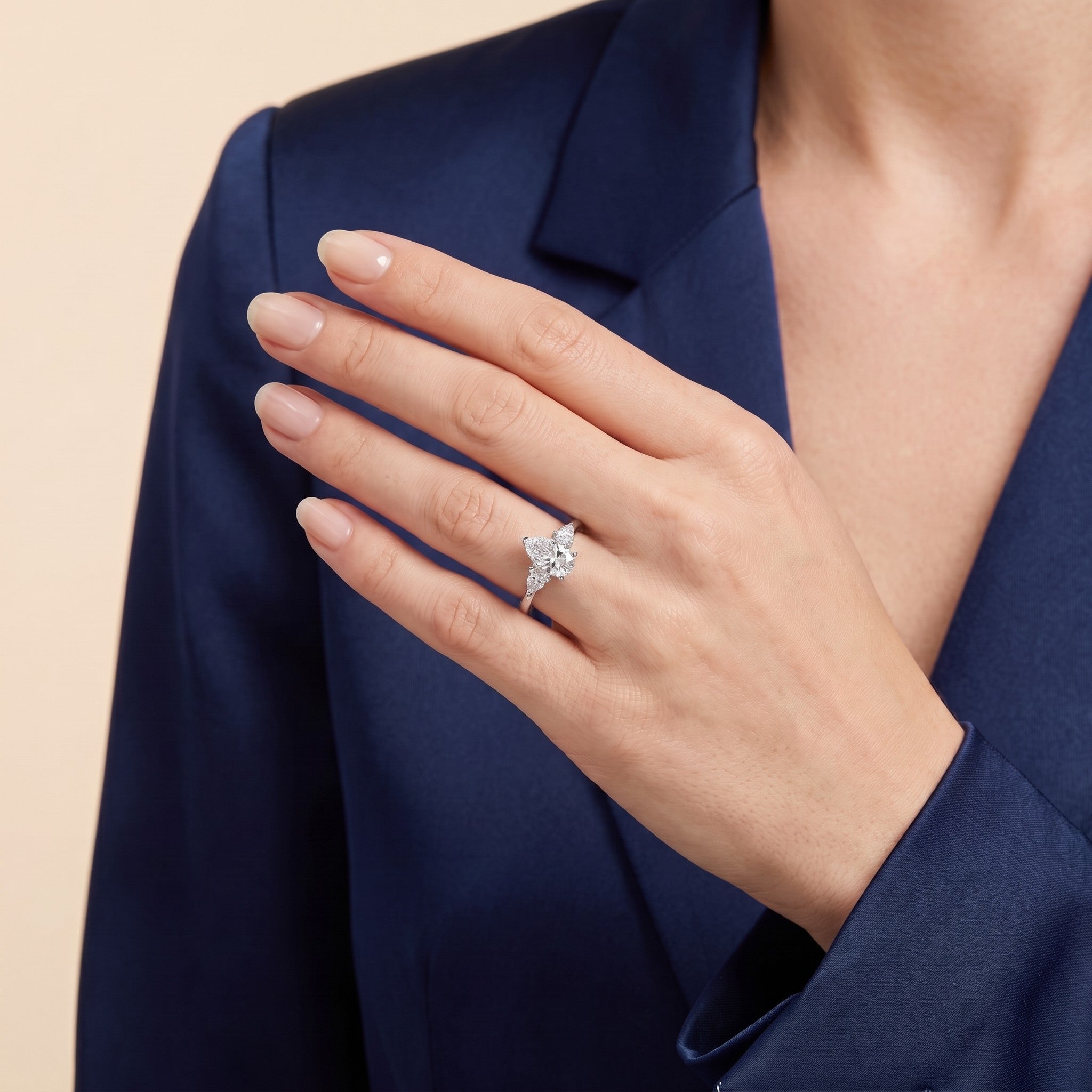 The model is wearing the Terra Diamond Pear Cut White Gold Ring.