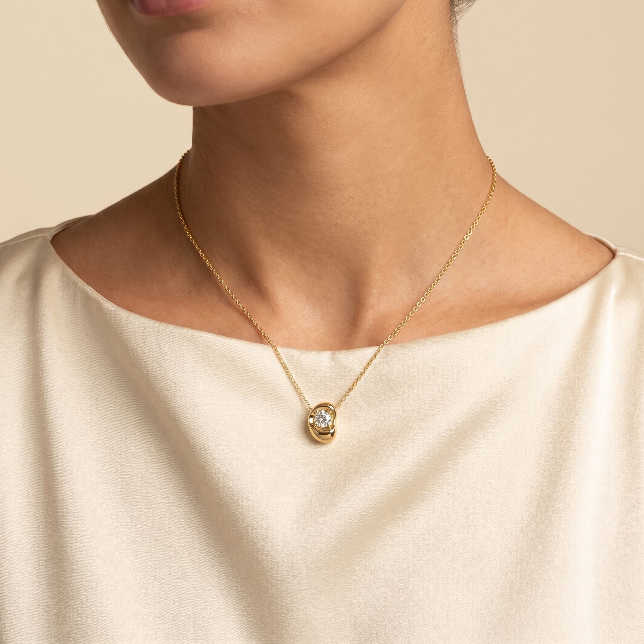 A model is wearing Fava Round Diamond Pendant Necklace in Gold | Juvetti