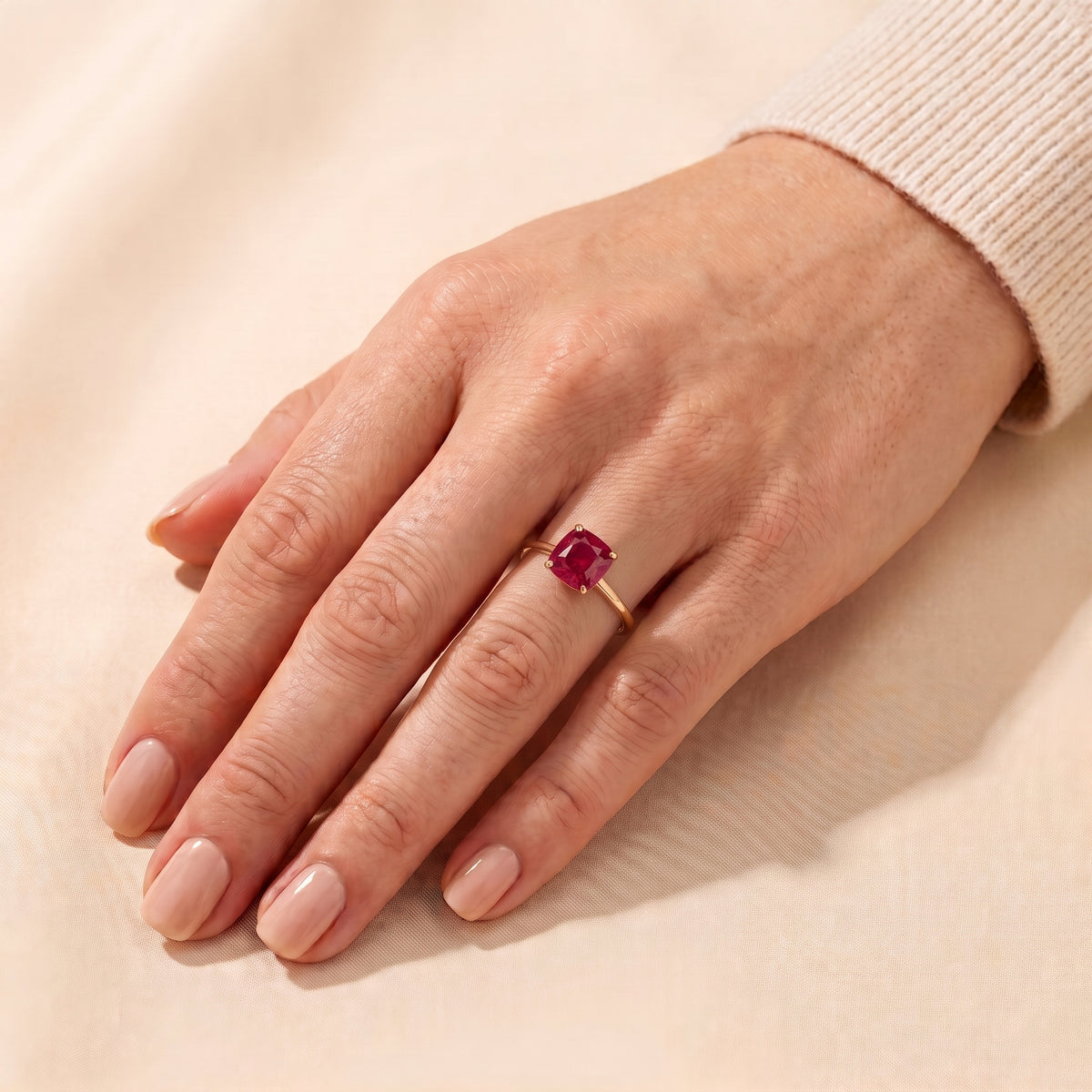 A model is wearing Iris Cushion Shape Ruby Cathedral Solitaire