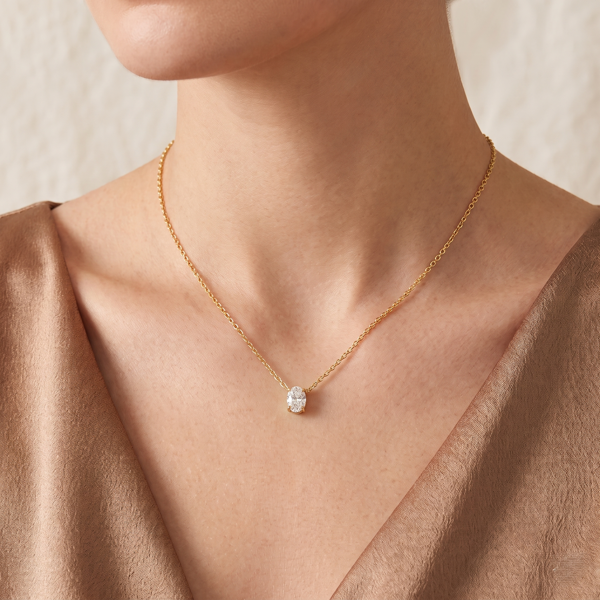 Model wears the Ovo oval diamond pendant necklace in gold