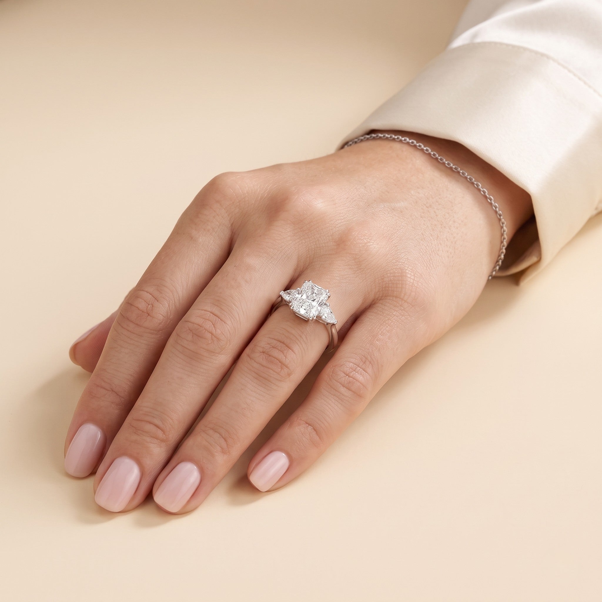 The model is wearing Bale Diamond Radiant Cut & Pear Cut White Gold Ring