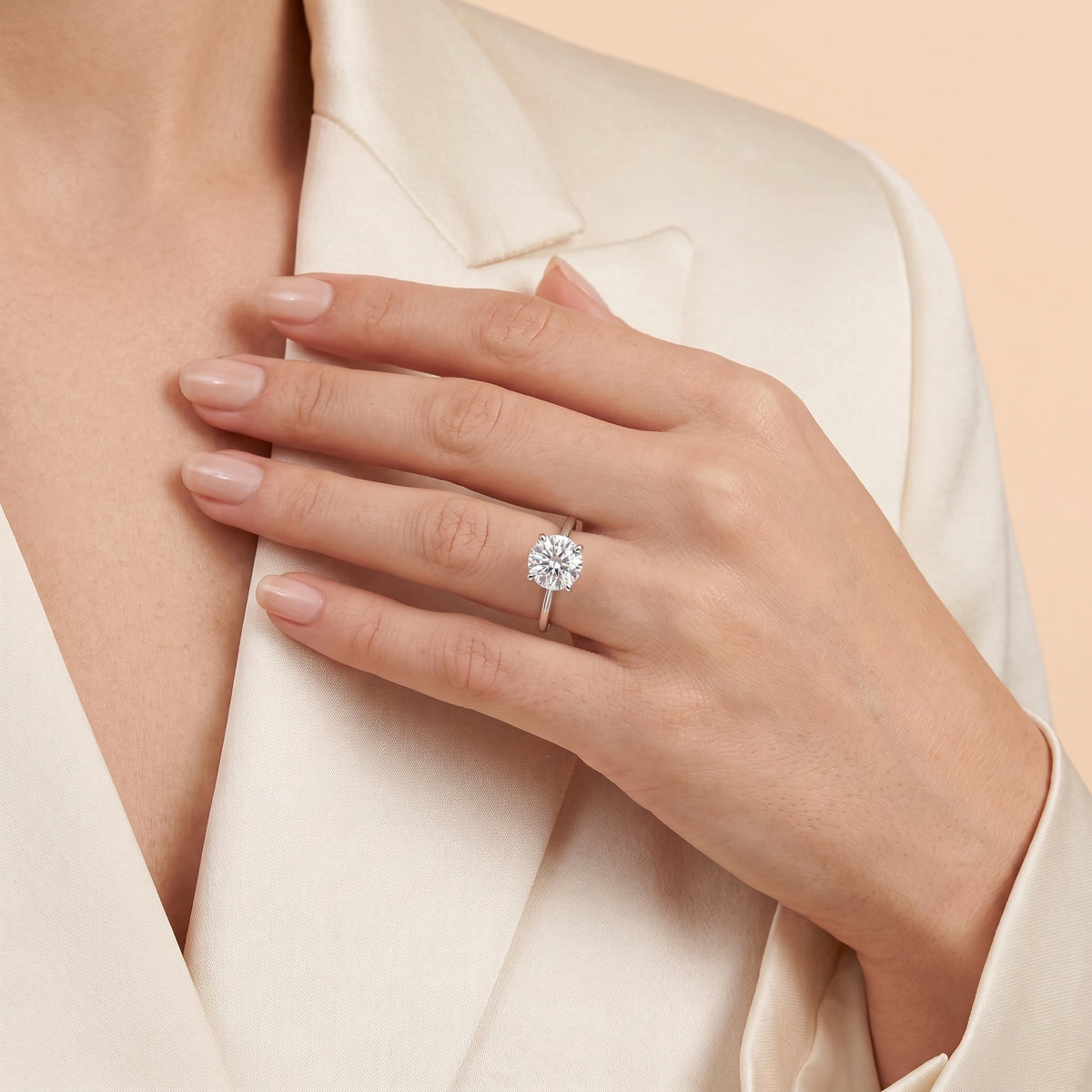 A model is wearing Nina Round Shape Diamond Cathedral Solitaire Ring