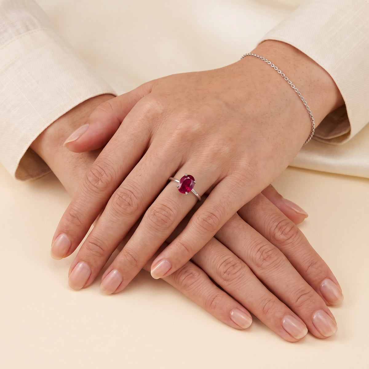 A model is wearing Lyra Oval Shape Ruby Cathedral Solitaire Ring in White Gold