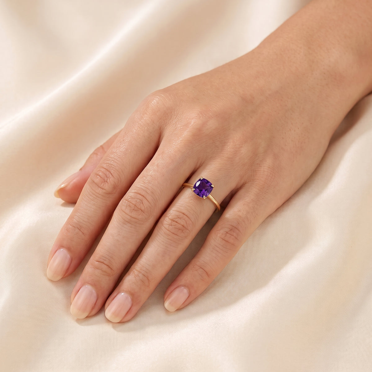 A model is wearing Iris Cushion Shape Purple Sapphire Cathedral Solitaire