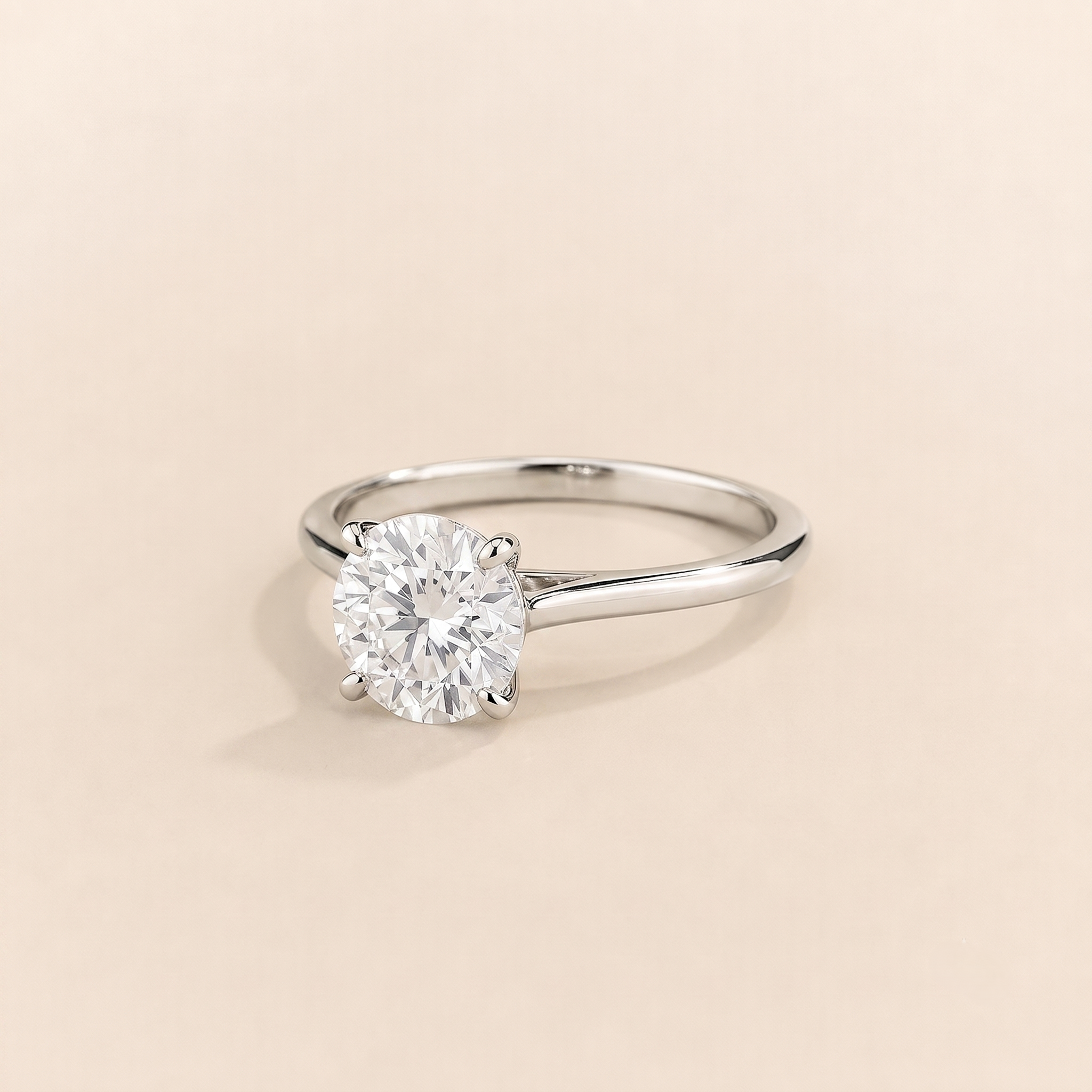 Kissen Ring in white gold, set with a round cut Diamond in an east–west setting.