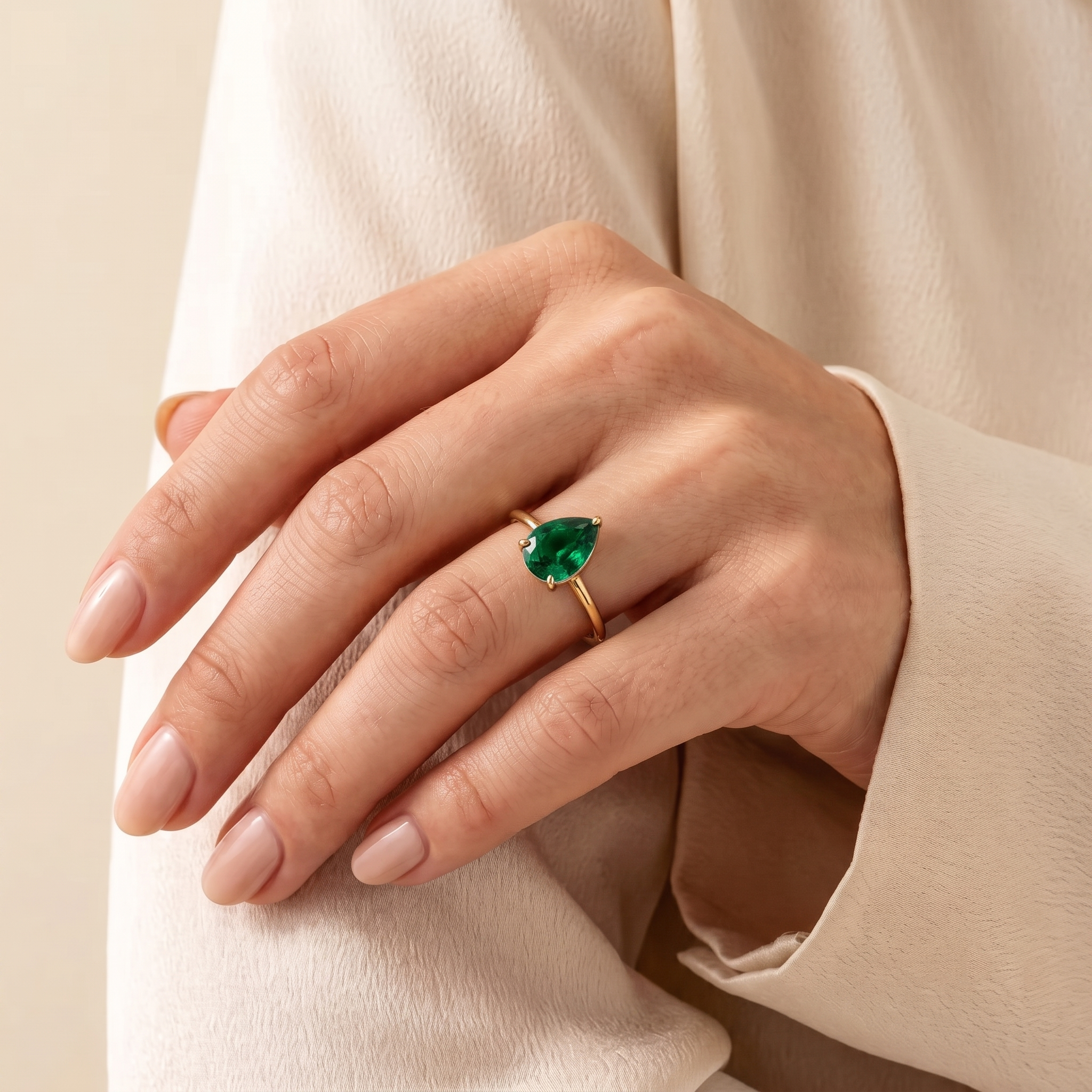 A model is wearing Pandal Pear Shape Emerald Cathedral Solitaire Ring