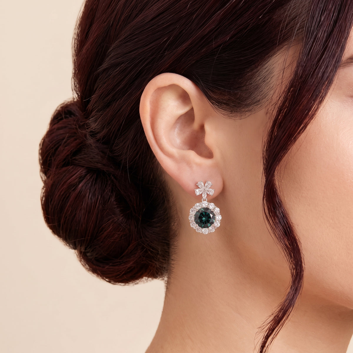 A model is wearing  The Antoinette Round Alexandite & Diamond Halo Pendant Earrings with Flower Bail
