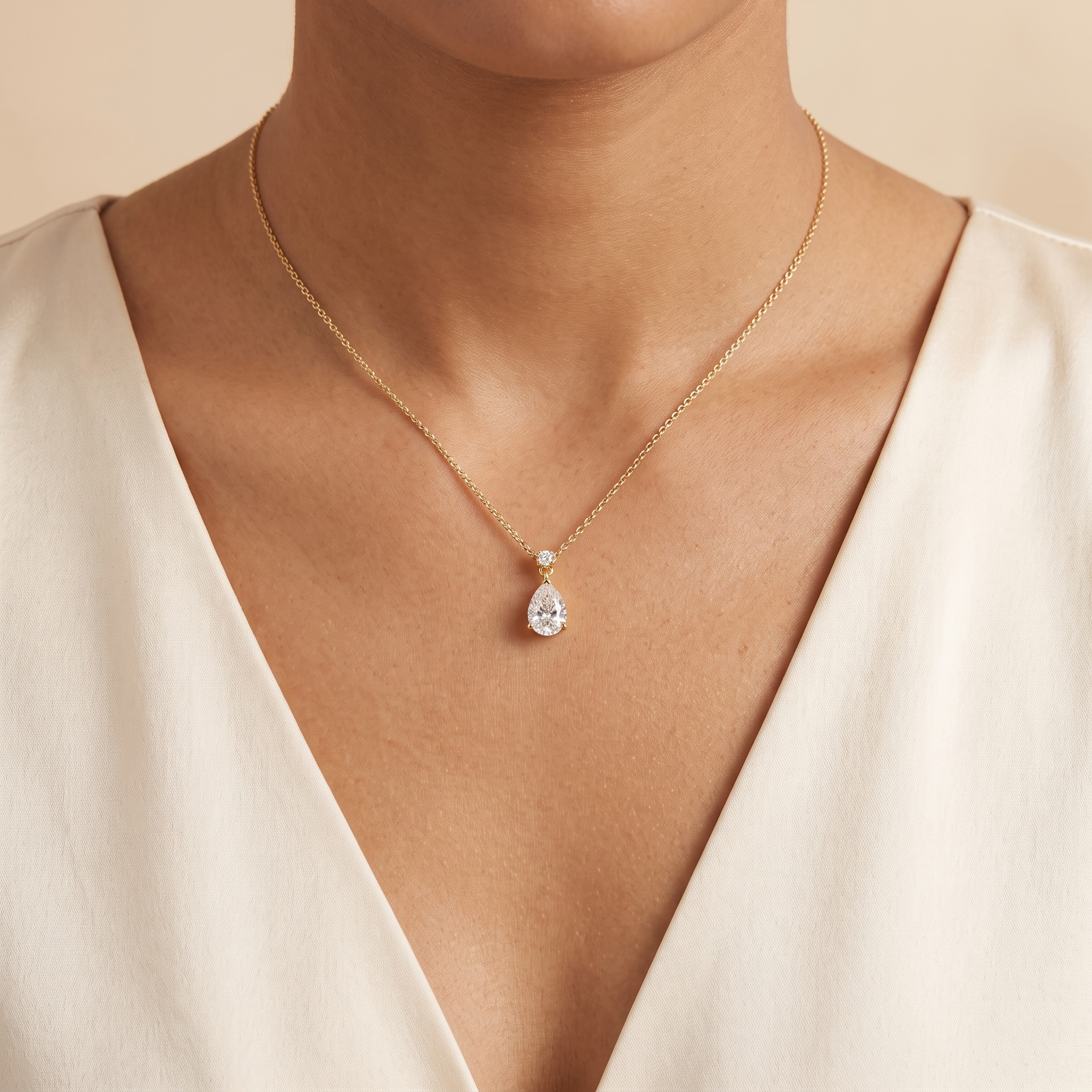 A model is wearing Pisa Diamond Pear Drop Pendant Necklace In Gold - Large