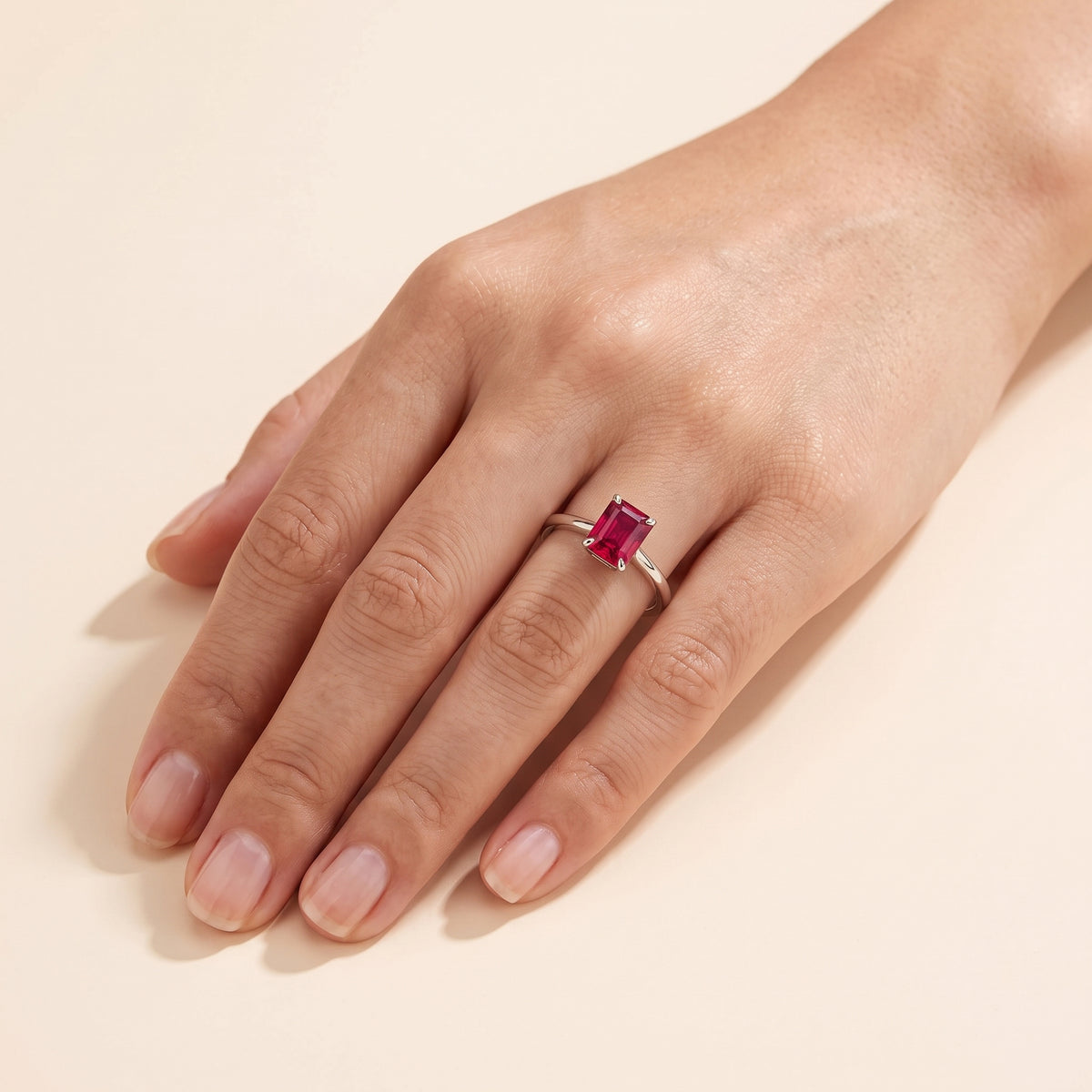 A model is wearing Clair Radiant Shape Ruby Cathedral Solitaire Ring 