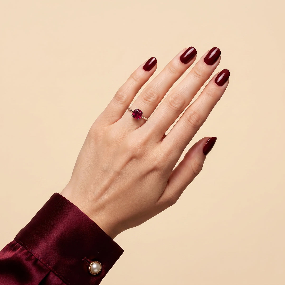 A model is wearing Iris Cushion Shape Ruby Cathedral Solitaire