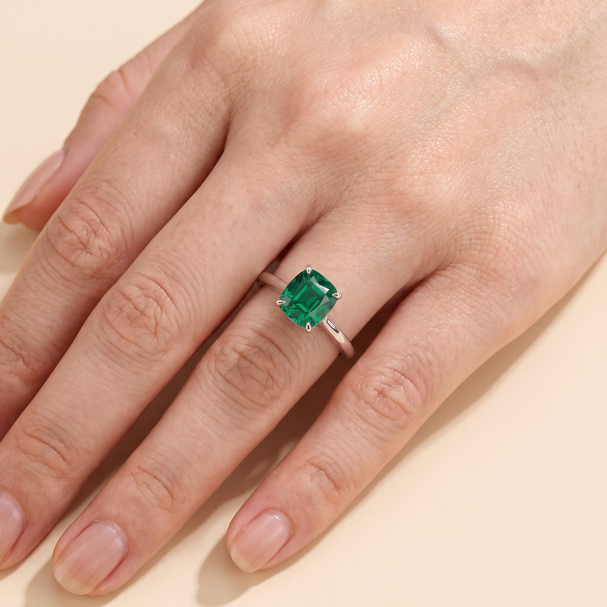 A model is wearing Pandal Cushion Shape Emerald Cathedral Solitaire 