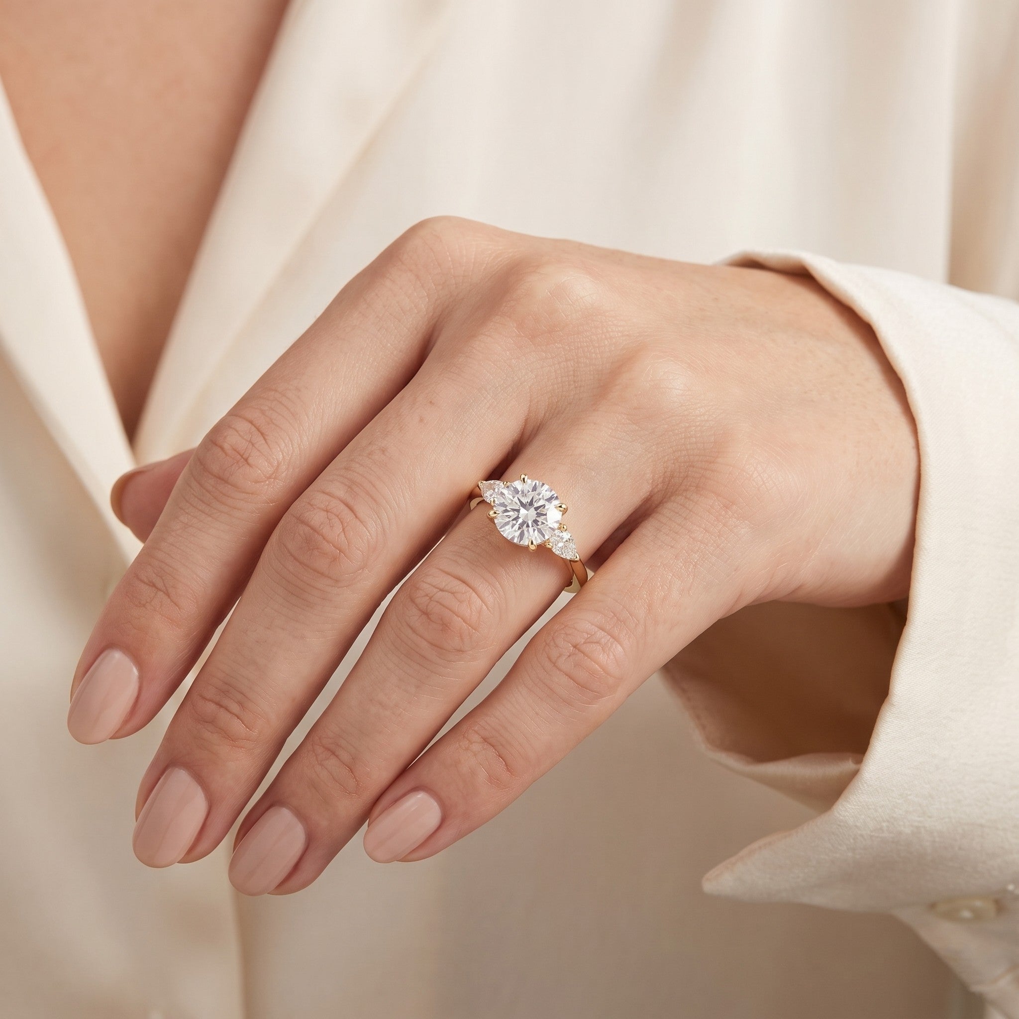The model is wearing Rosey Diamond Round Cut & Pear Cut Gold Ring