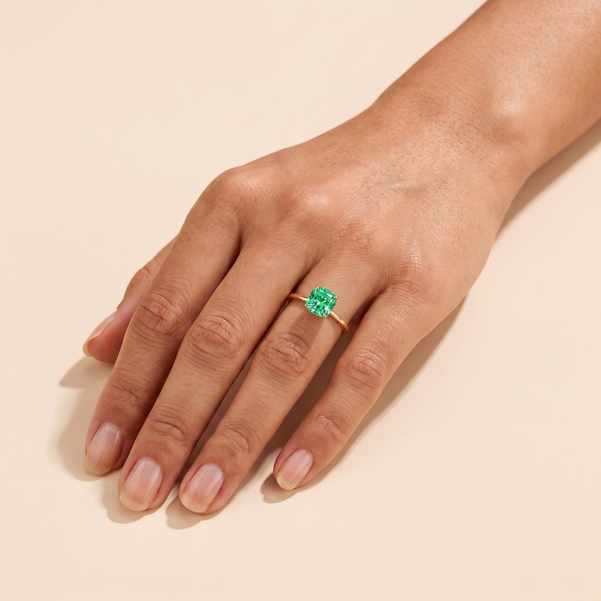 A model is wearing Iris Cushion Shape Green Sapphire Cathedral Solitaire