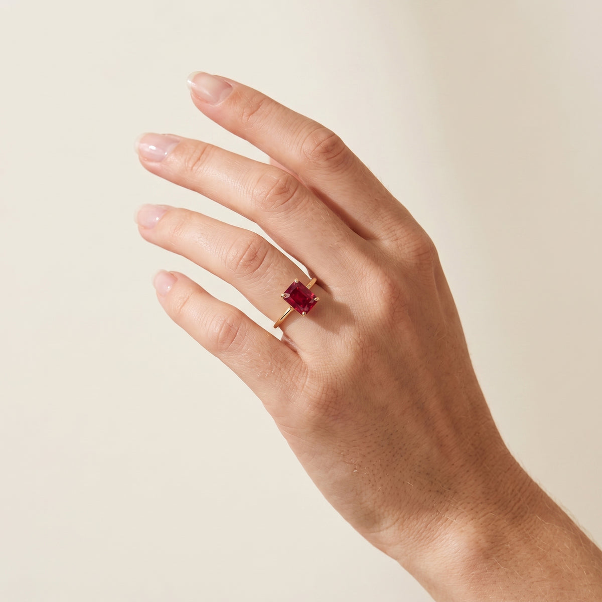 A model is wearing Clair Radiant Shape Ruby Cathedral Solitaire Ring