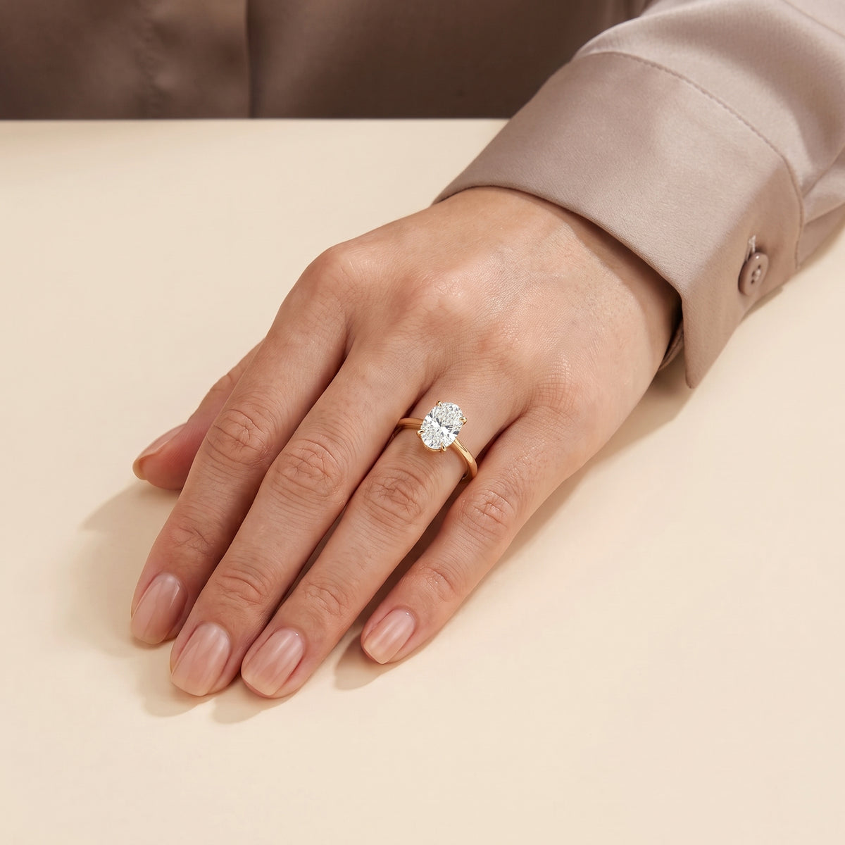The model is wearing Oval Shape Diamond Cathedral Solitaire Ring in Gold