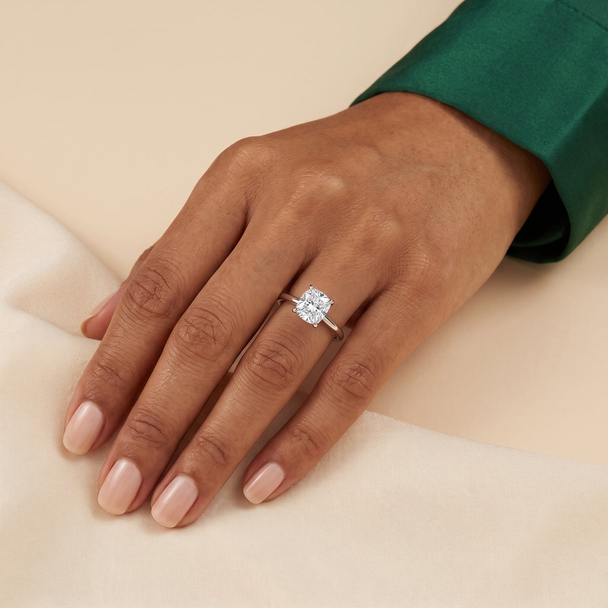 The model is wearing Iris Cushion Shape Diamond Cathedral Solitaire Ring in White Gold 