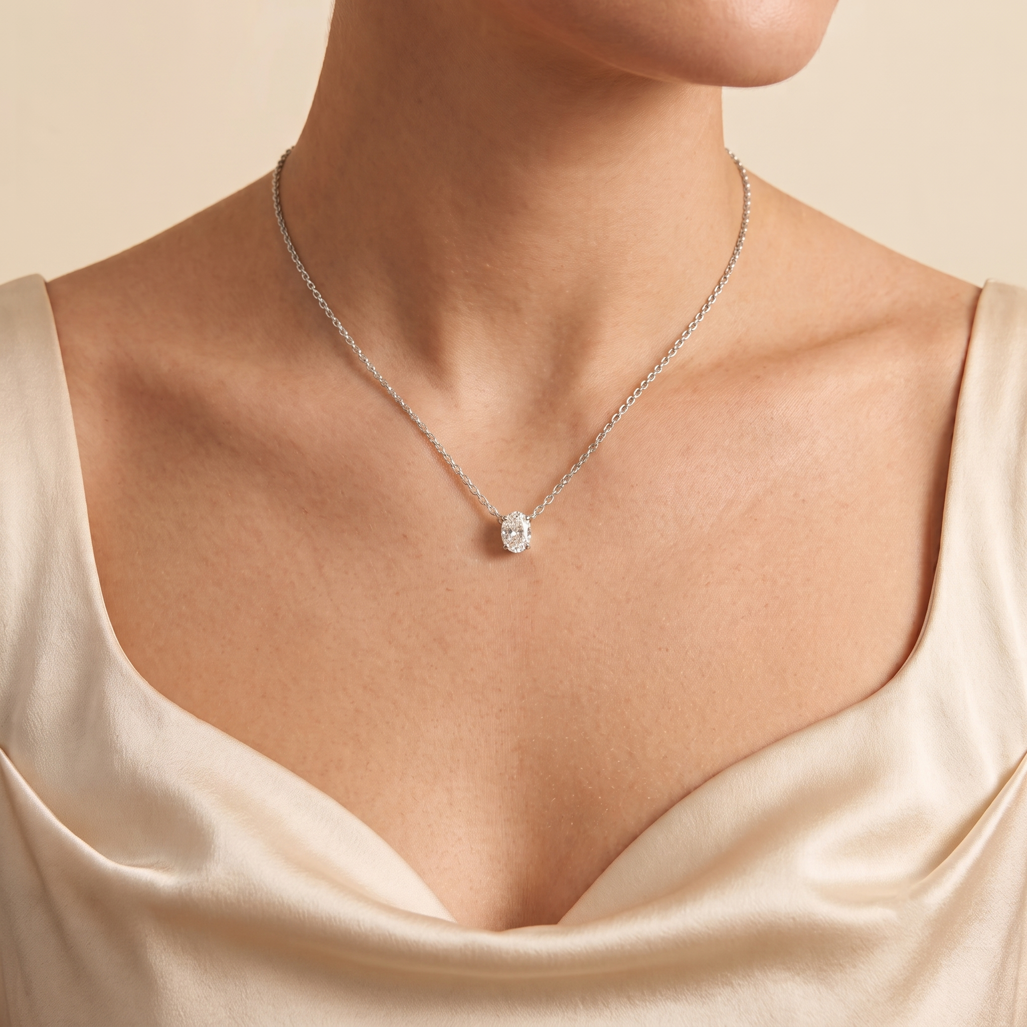 Model wears the Ovo oval diamond pendant necklace in white gold
