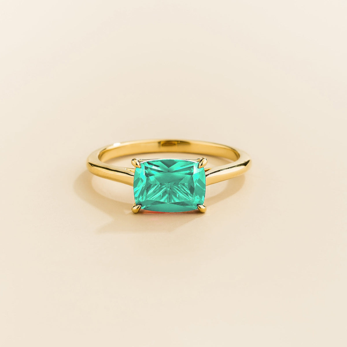 East-west cushion-cut lab-grown Paraiba solitaire ring in gold | Juvetti London
