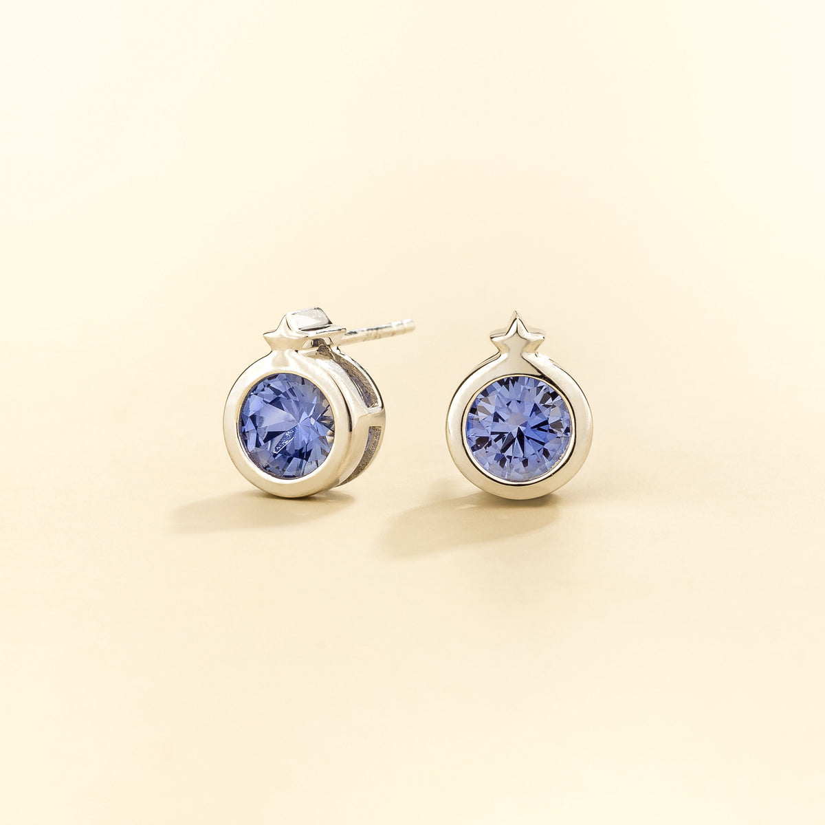 Kiki Blue Sapphire Round Bezel Set Solitaire Earrings in White Gold three quarters