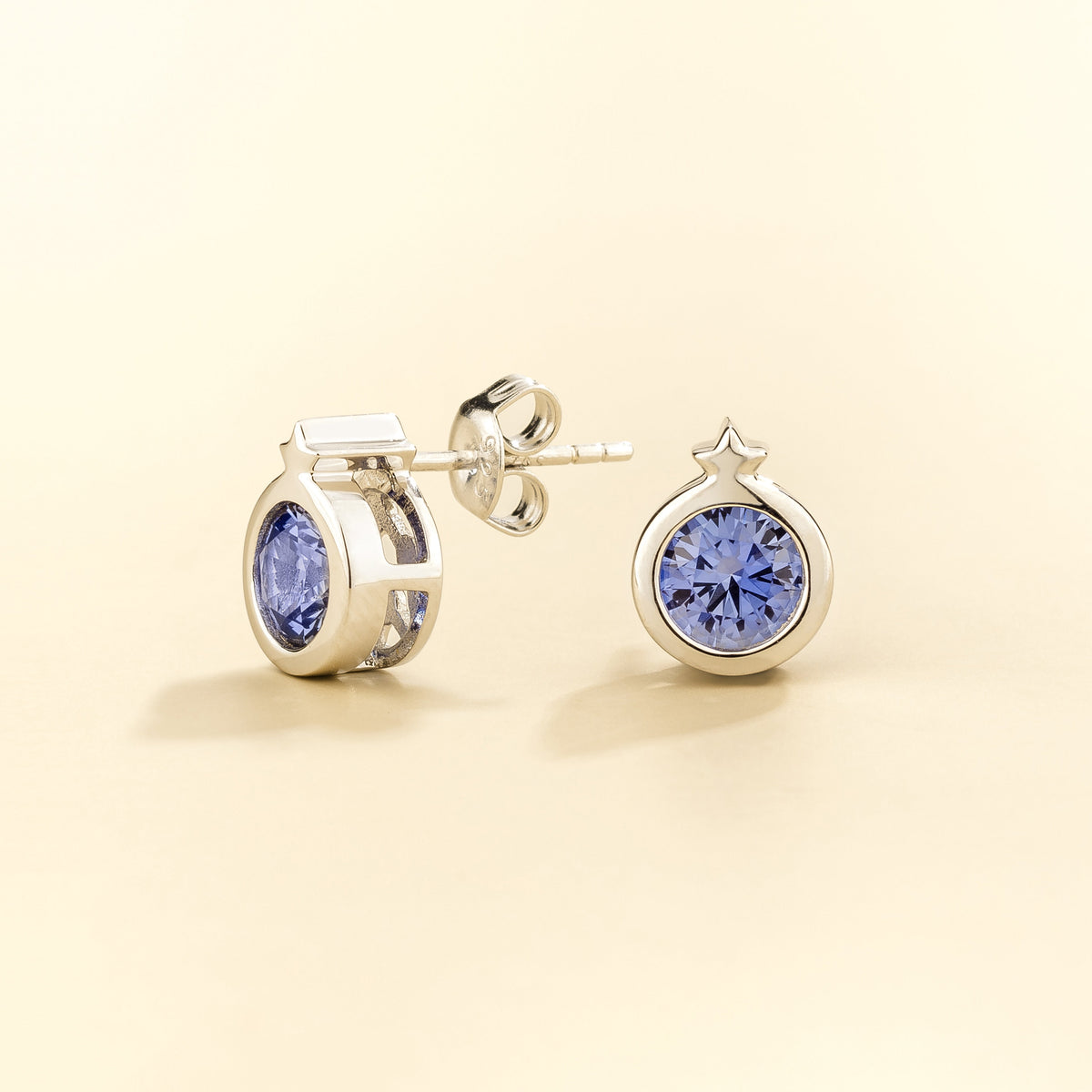 Kiki Blue Sapphire Round Bezel Set Solitaire Earrings in White Gold angled view