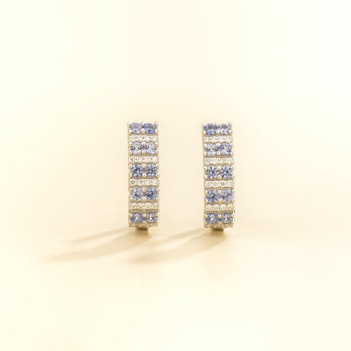 Tina pastel blue sapphire & diamond huggie hoop earrings in white gold, front view