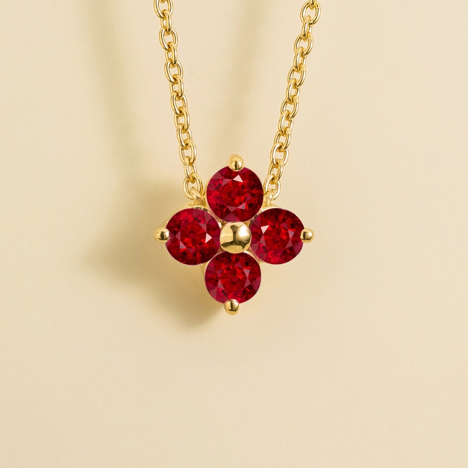 Front view of the Clover Ruby Necklace In Gold, handcrafted by Juvetti London