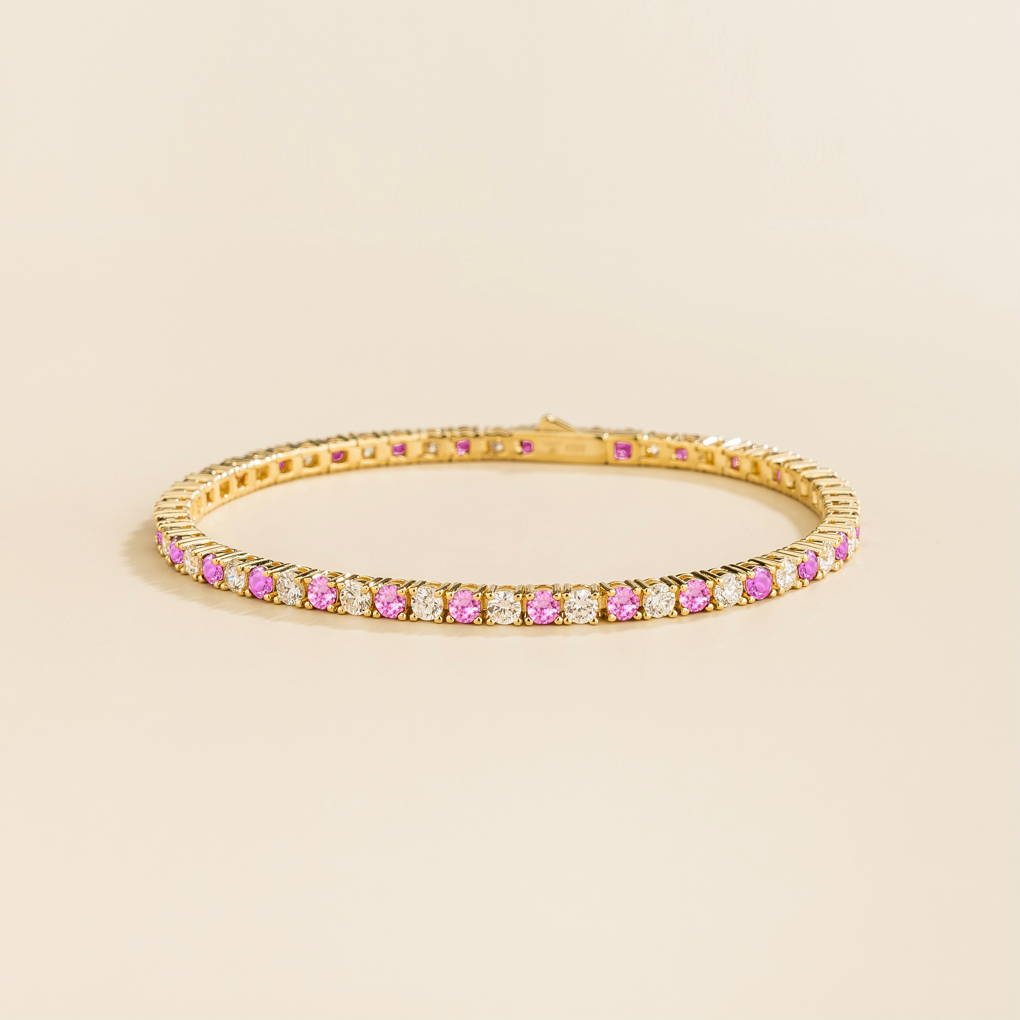 ciclo gold tennis bracelet with round pink sapphire and lab grown diamonds