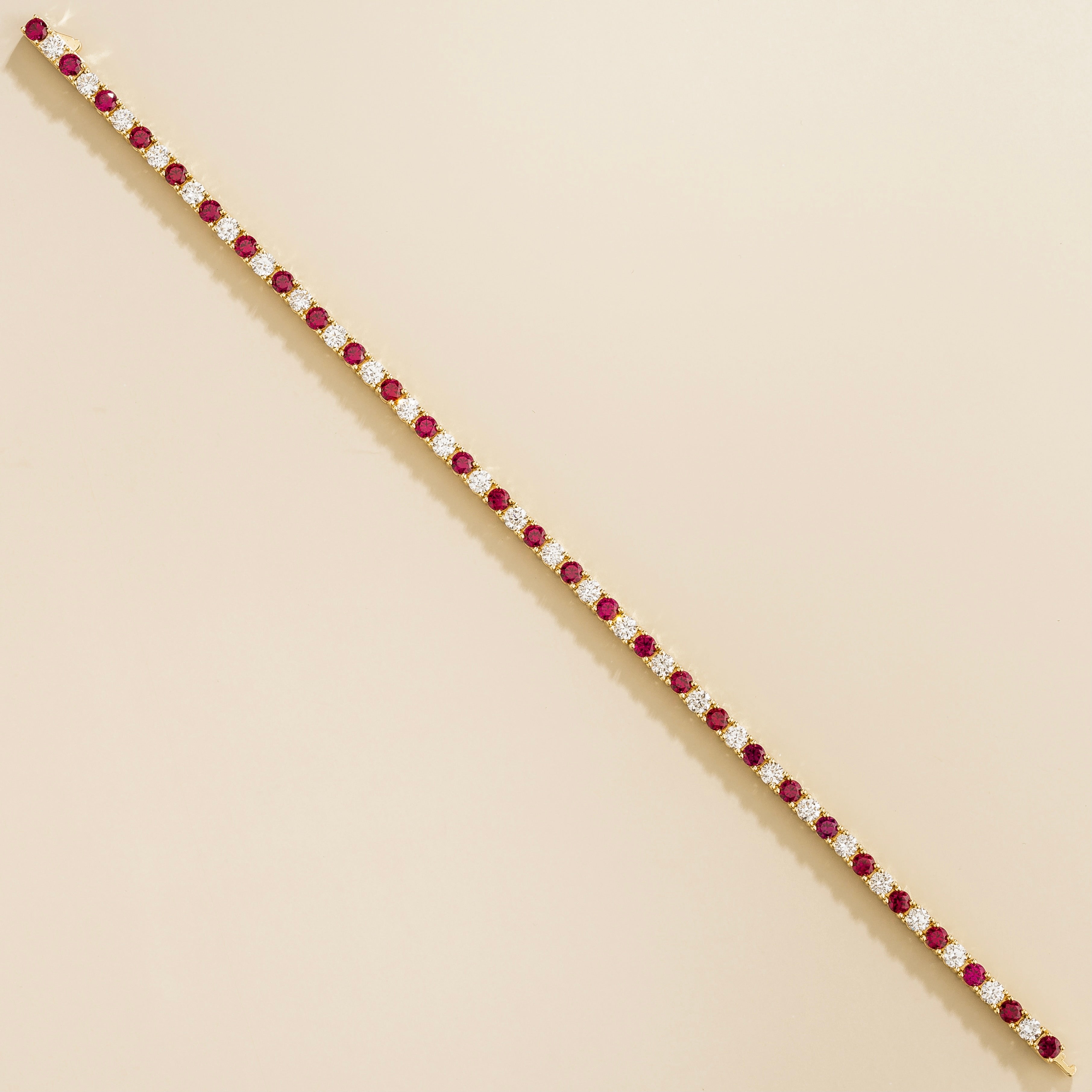 luxury tennis bracelet in gold set with ruby and lab grown diamond stones