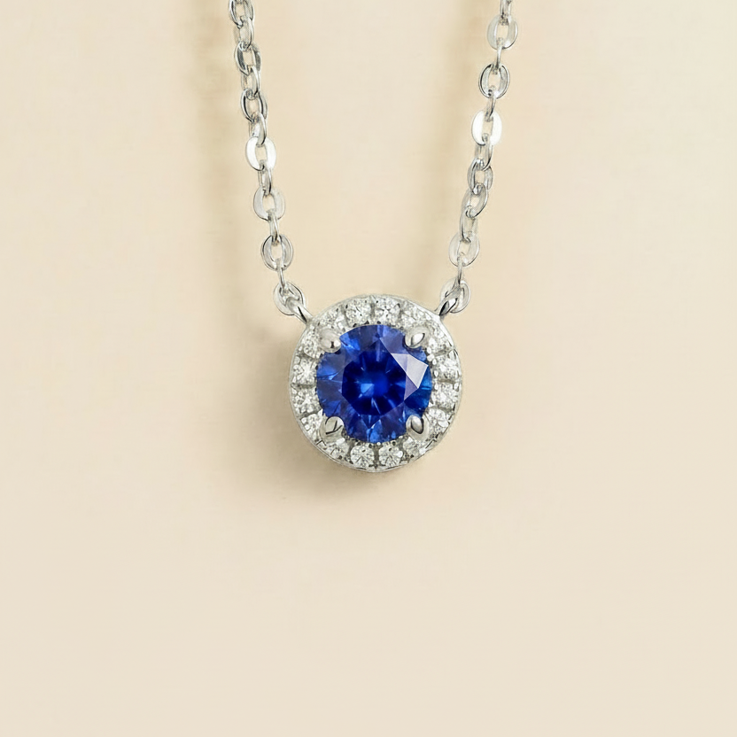 Round lab-grown blue sapphire and diamond halo Mars necklace in white gold | Juvetti London
