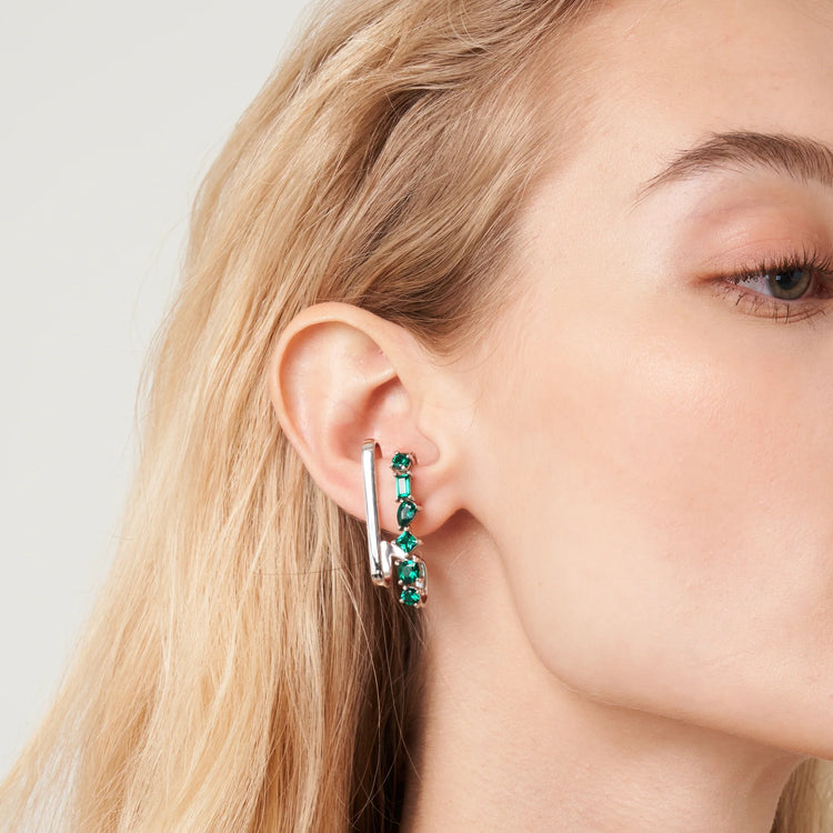A model wearing Serene cuff earrings made with lab grown emerald gem stones.