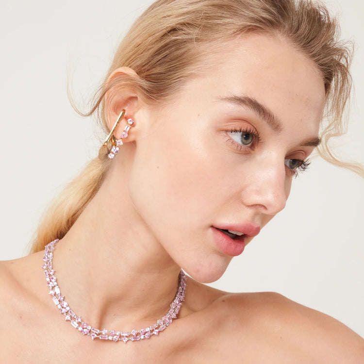 A model is wearing Serene cuff earrings and Lago Rosa layered necklace set with lab grown pink sapphire gem stones.