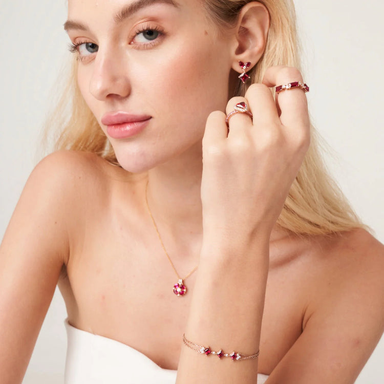 A model wearing Forma ring and bracelet set with lab grown diamond and ruby. She also wears Diana ring, Amore earrings and Pristi necklace all set with lab grown ruby and diamonds.