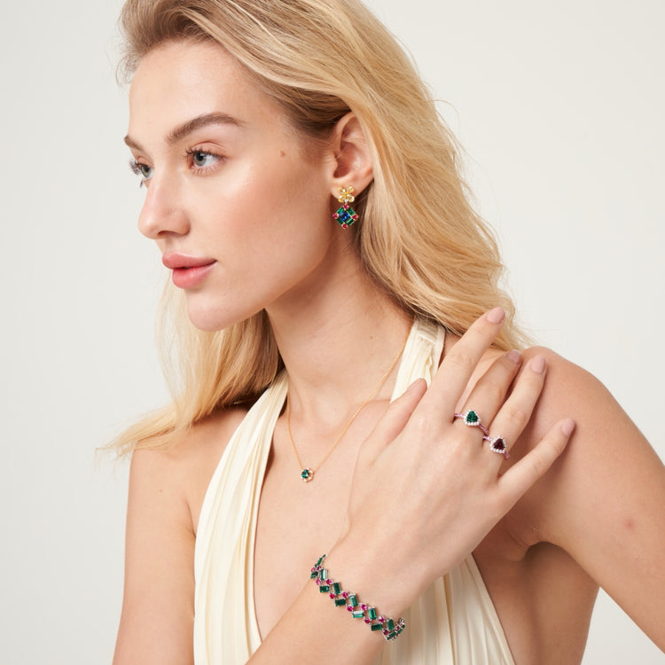 A model wearing Dante bracelet, Diana rings, Melba necklace and Medina earrings set with lab grown diamond, yellow sapphire, blue sapphire, emerald, ruby and pink sapphire gem stones.