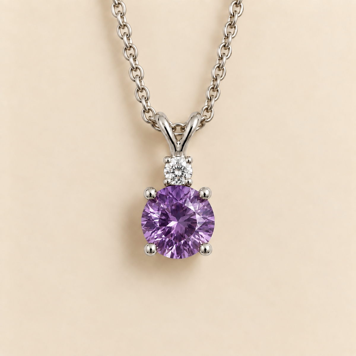 Front view of the Joie Round Purple Sapphire & Diamond Drop Pendant Necklace In White Gold, handcrafted by Juvetti London