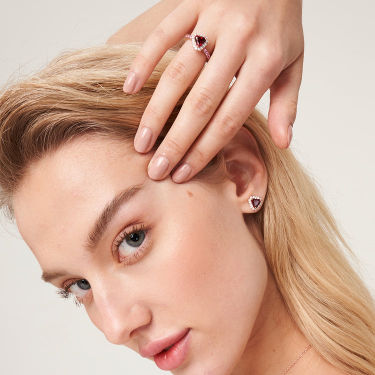 A model wearing Diana ring and earrings set with lab grown diamonds, ruby and pink sapphire.