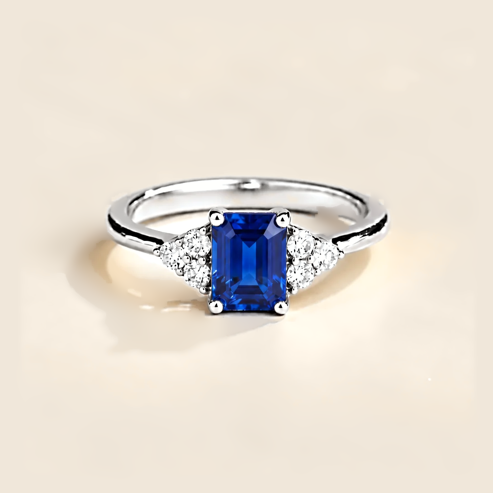 Emerald-cut lab-grown blue sapphire and diamond Chateau ring in white gold | Juvetti London