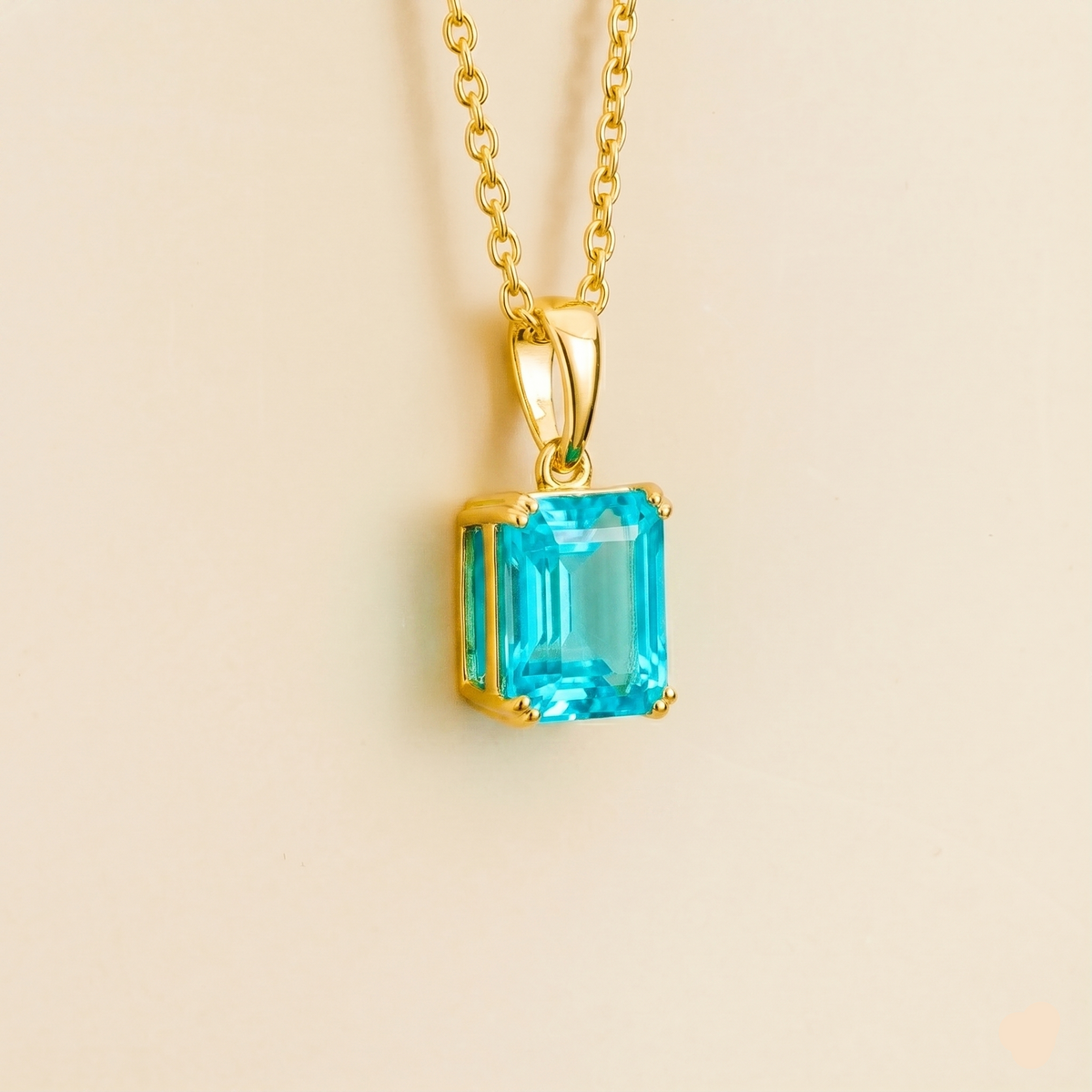 Side view of the Thamani Paraiba Sapphire Emerald-Cut Solitaire Pendant Necklace in Gold