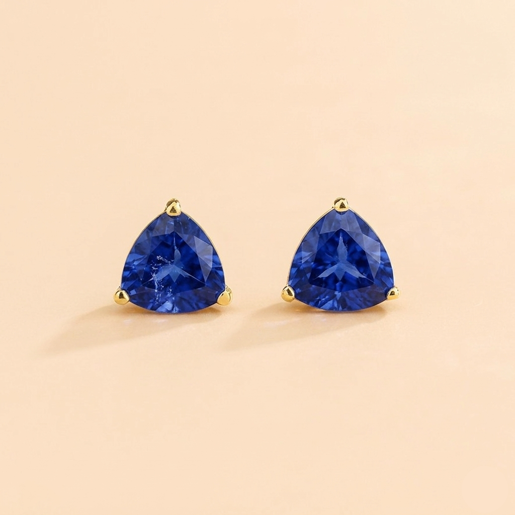 Trillion-cut lab-grown blue sapphire solitaire stud earrings in gold | Juvetti London