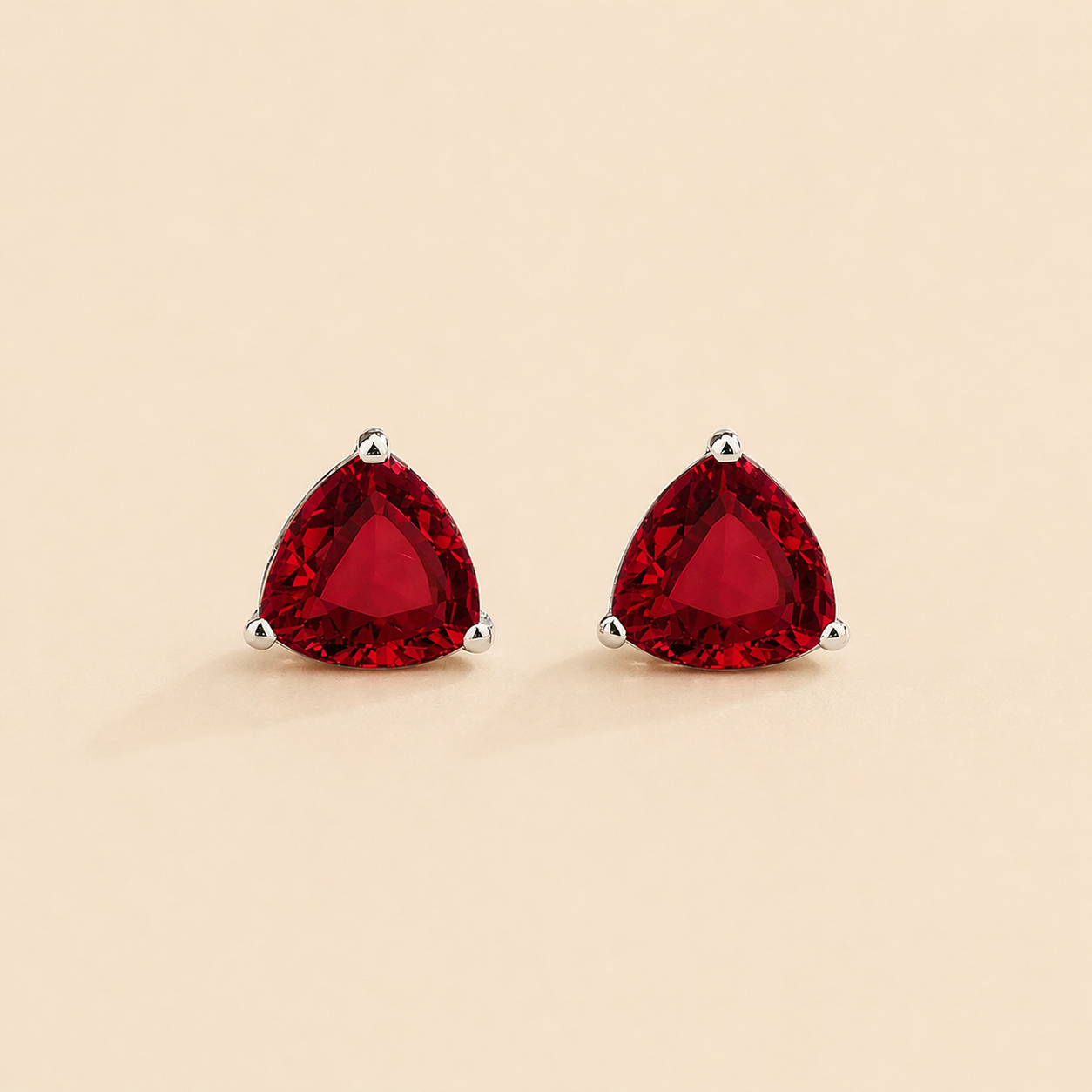 Trillion Ruby Solitaire Stud Earrings in White Gold