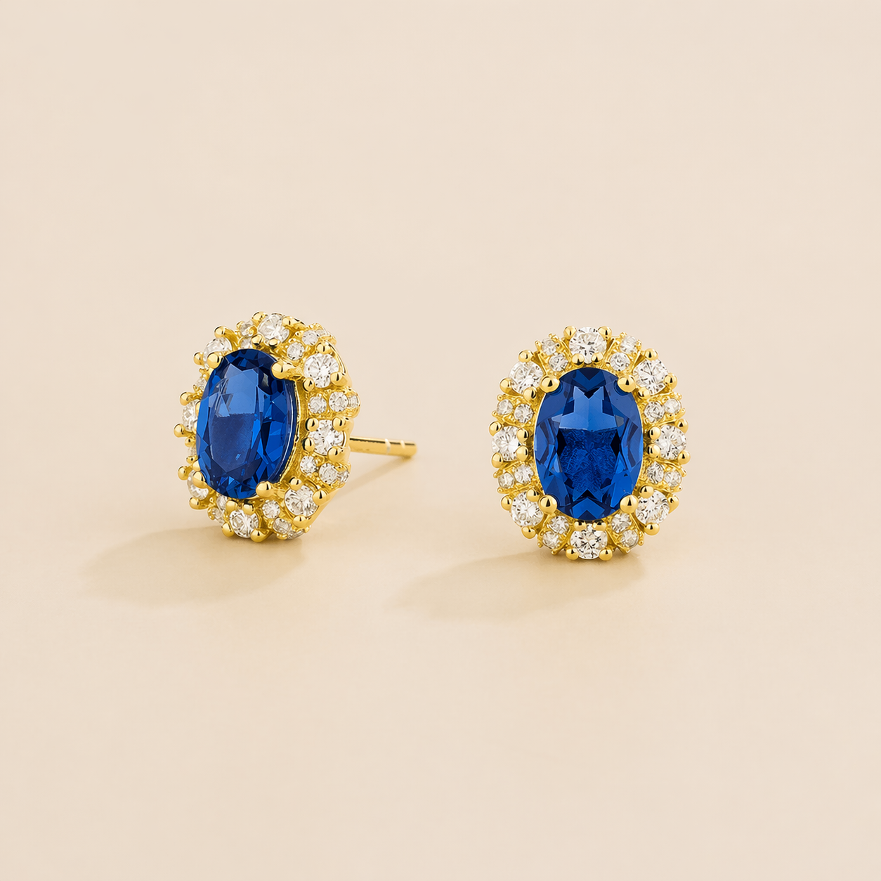 Viva Oval Blue Sapphire Halo Stud Earrings with Diamond Accents in Gold