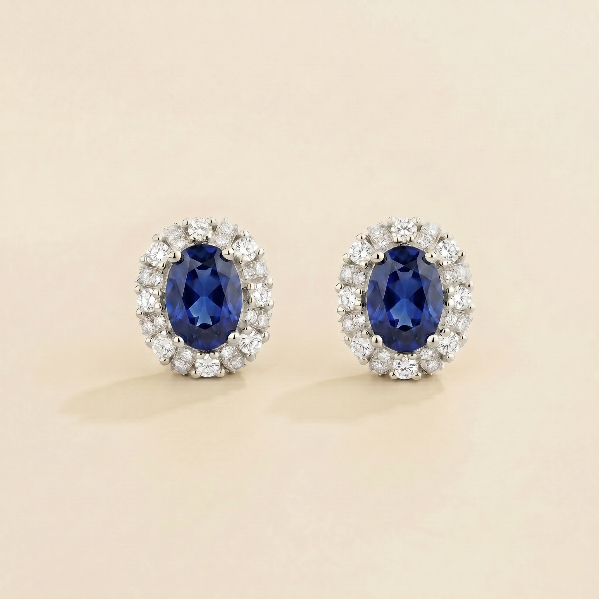 Viva Oval Blue Sapphire Halo Stud Earrings with Diamond Accents in White Gold