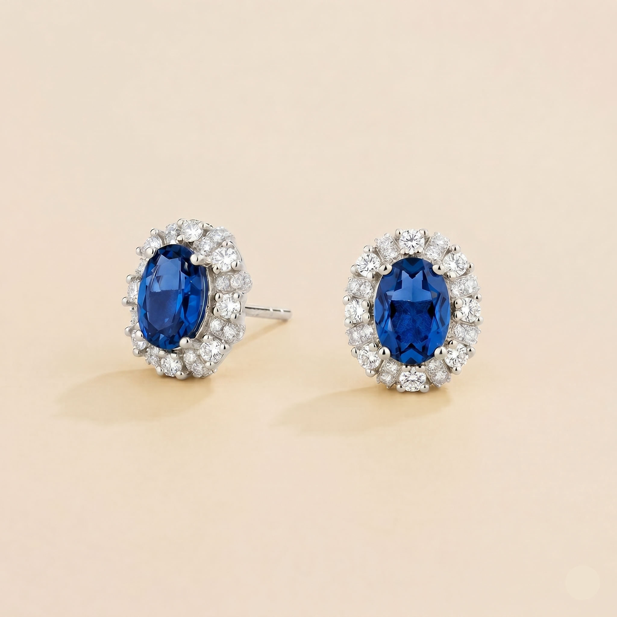Viva Oval Blue Sapphire Halo Stud Earrings with Diamond Accents in White Gold