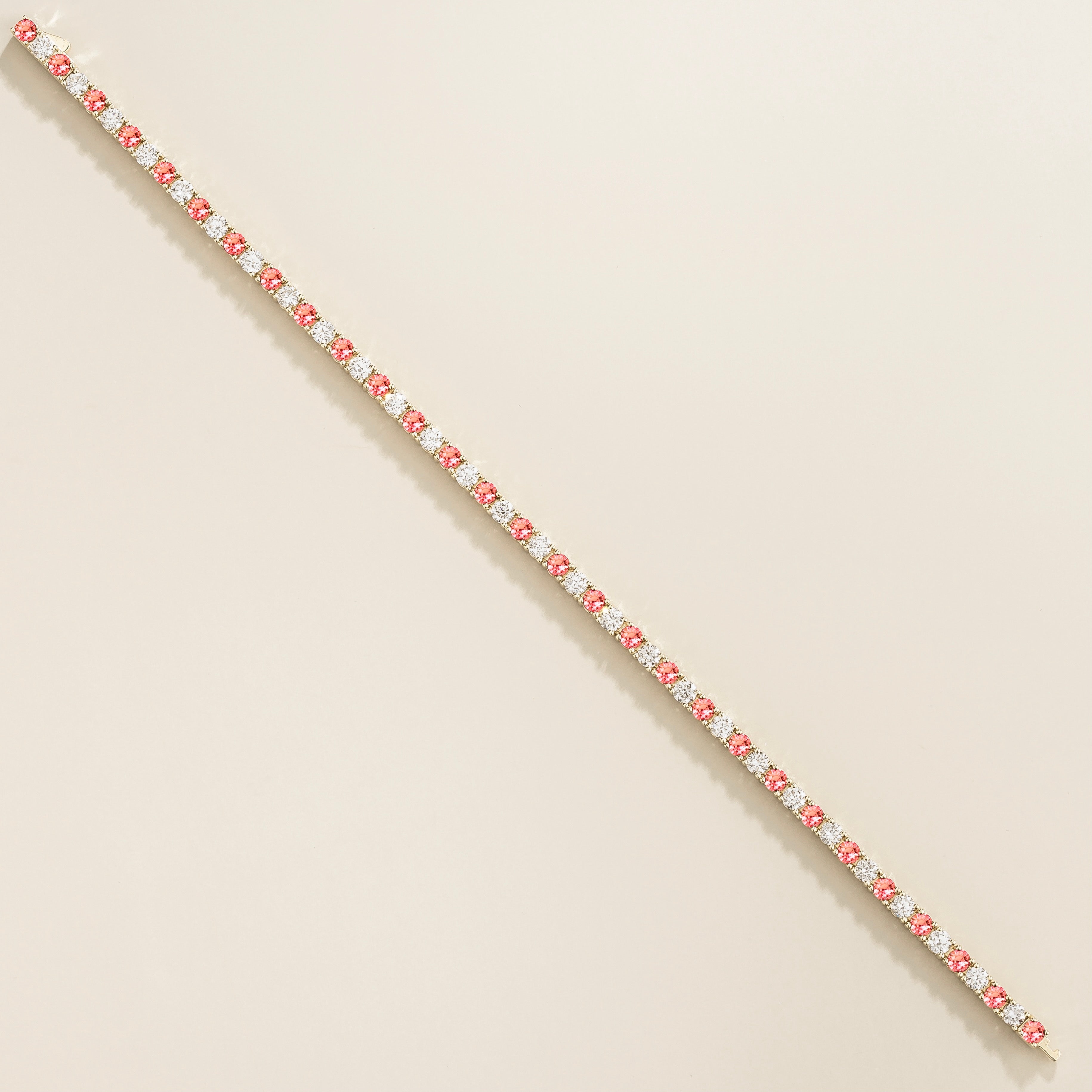 white gold bracelet featuring round padparadscha sapphire gemstones and lab grown diamonds