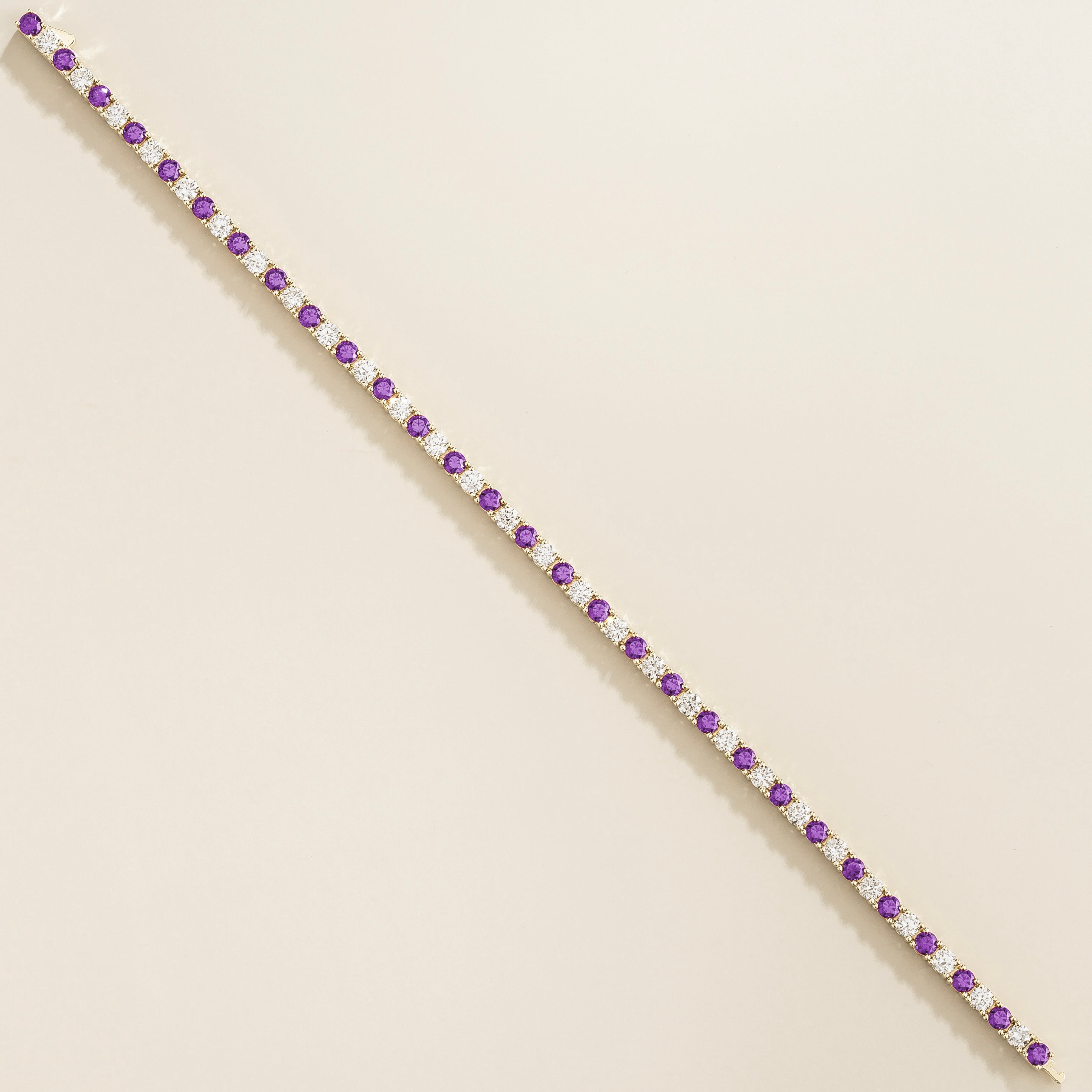 white gold bracelet featuring round purple sapphire gemstones and lab grown diamonds