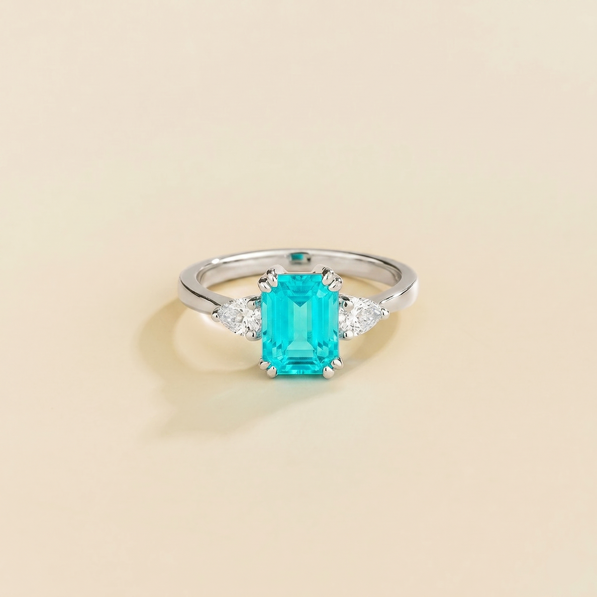 Emerald-cut lab-grown Paraiba ring with pear-cut diamond sides, Ailes design in white gold