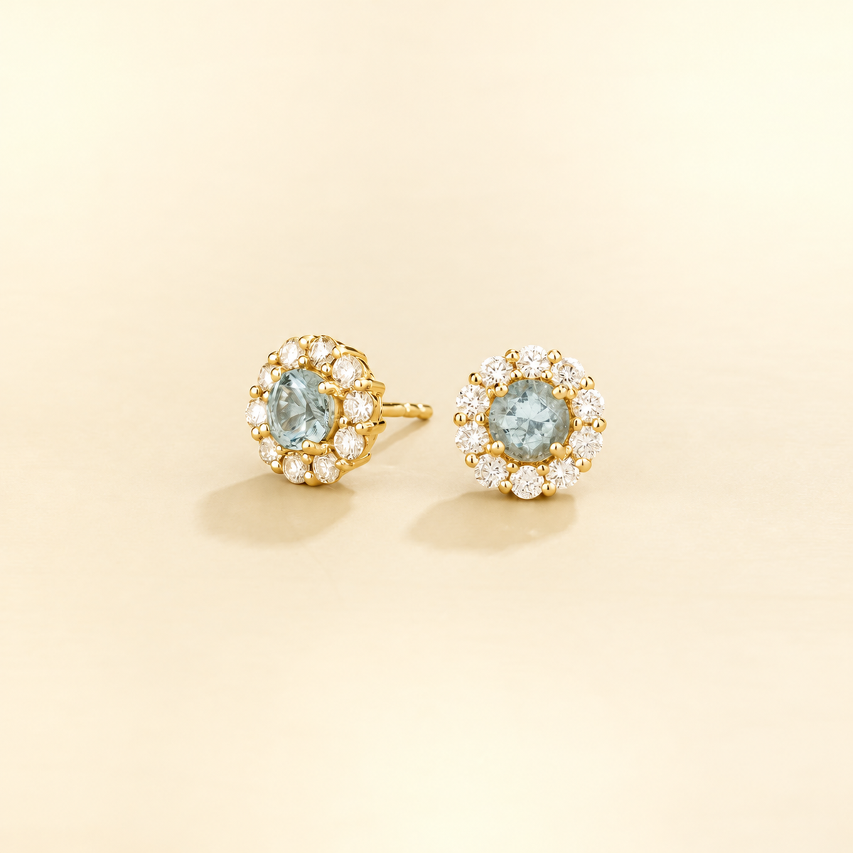 Floret round aquamarine and diamond halo stud earrings in yellow gold, angled view